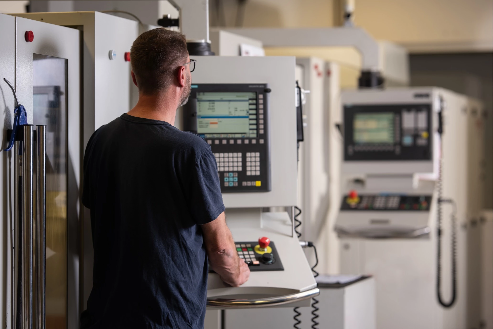 A person programming a milling machine