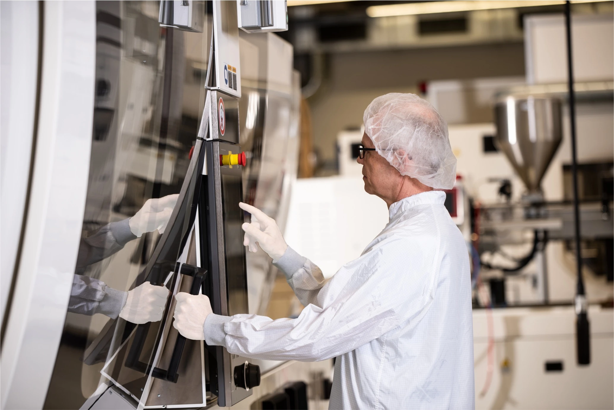 A person programming a molding machine